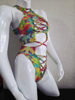 Colorful tie-dye bikini top on a mannequin against a plain background