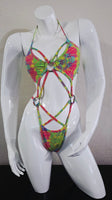 Colorful tie-dye harness on a white mannequin against a plain background