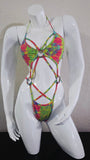 Colorful tie-dye harness on a white mannequin against a plain background