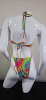 Colorful tie-dye hair bow on a white mannequin head against a plain background