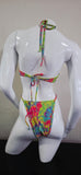 Colorful tie-dye hair bow on a white mannequin head against a plain background