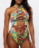 Woman wearing a colorful tie-dye bikini set on a white background