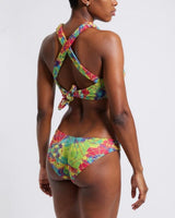Woman wearing a colorful bikini set on a white background
