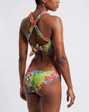 Woman wearing a colorful bikini set on a white background