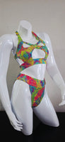 Colorful tie-dye sandal on a white mannequin against a plain background