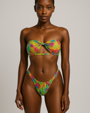 Model wearing a colorful tie-dye bikini set against a neutral background
