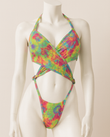 Colorful tie-dye bikini on a mannequin against a plain background